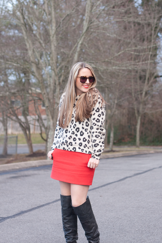 Black over the knee boots with a red mini