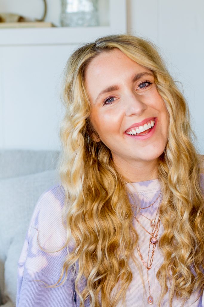 Heatless Waves by popular Nashville beauty blog, Pearl and Twirls: image of a woman with long wavy blond hair and wearing a purple tie dye shirt.. 